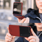 クリムゾンレッドのクリップパターンケースを装着したGalaxy Z Flip 8をの手で開いて持つ上下2つのカット。